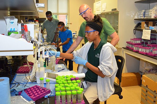 John Daniels working with students in laboratory