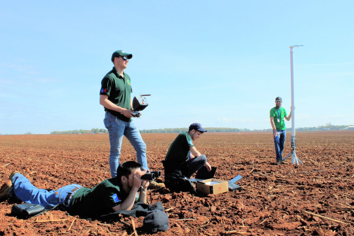 49ers Rocketry team members working in field