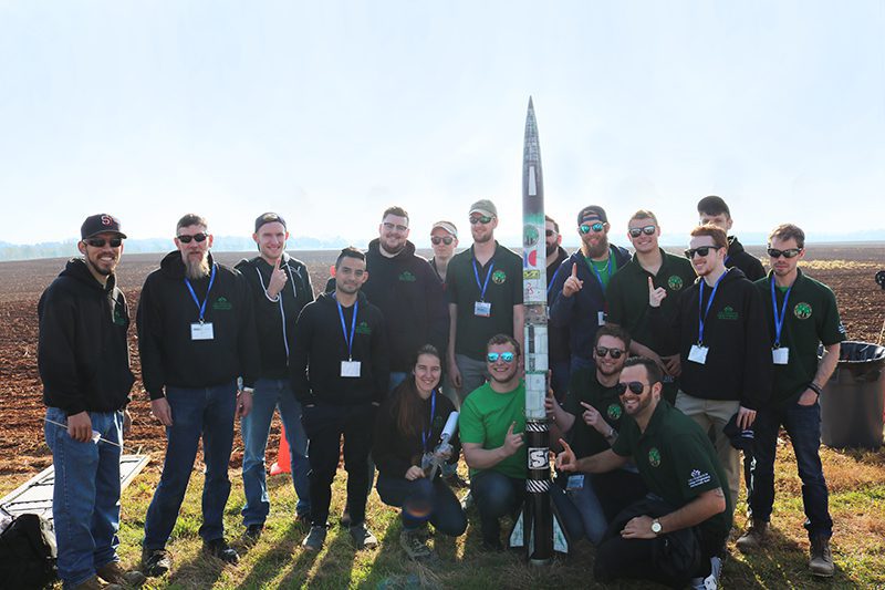 49er Rocketry Team members pose with rocket they built