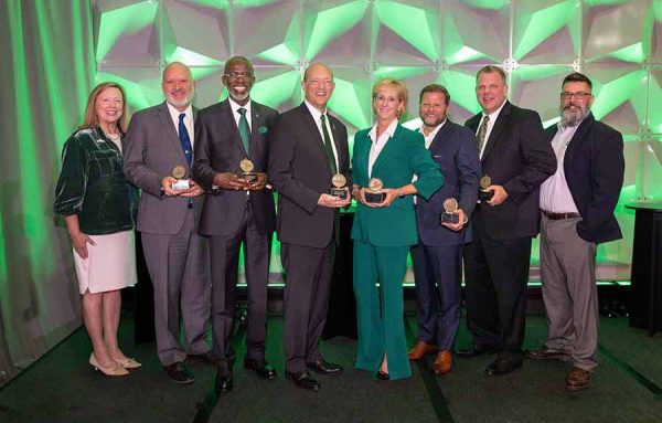 2024 UNC Charlotte Alumni Award recipients standing with Chancellor Gaber