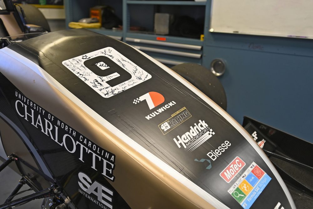 Closeup of the race car showcasing autographs of 49er Racing team members